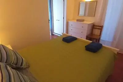a bedroom with a bed with two pillows on it at Bela Vista Algarve in Albufeira