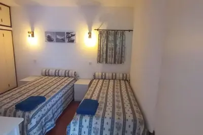 a room with two beds and a window at Bela Vista Algarve in Albufeira