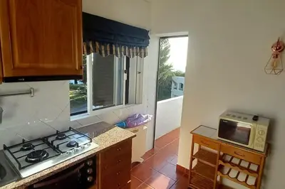a kitchen with a stove top oven next to a window at Bela Vista Algarve in Albufeira
