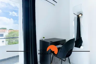 a room with a black chair next to a window at #266 Luxurious Villa Bellagio in Albufeira
