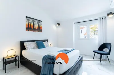 a bedroom with a bed with a home holidays sign on it at #266 Luxurious Villa Bellagio in Albufeira
