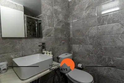 a bathroom with a toilet and a sink and a mirror at #267 Cozy Villa Casablanca in Albufeira