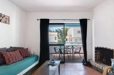a living room with a couch and a table at Mar Azul 4 in Albufeira