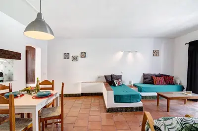 a kitchen and living room with a table and chairs at Mar Azul 4 in Albufeira