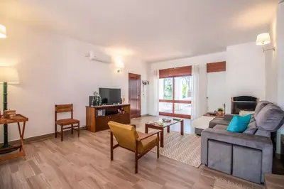 a living room with a couch and a table at Casa da Aldeia in Albufeira