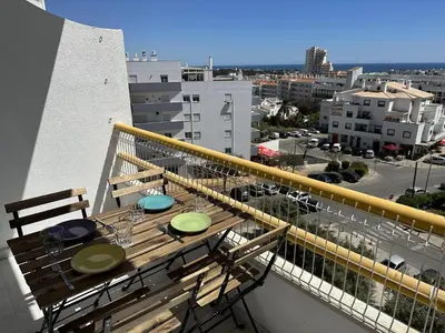 a balcony with a table and chairs on a balcony at Go4Portugal - Dinis - Luxe Condo with Pool, Airco, Seaview with two Balcony in Albufeira
