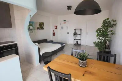 a living room with a table and a bed in a room at Go4Portugal - Dinis - Luxe Condo with Pool, Airco, Seaview with two Balcony in Albufeira