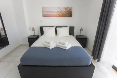 a bedroom with a bed with two towels on it at Go4Portugal - Dinis - Luxe Condo with Pool, Airco, Seaview with two Balcony in Albufeira