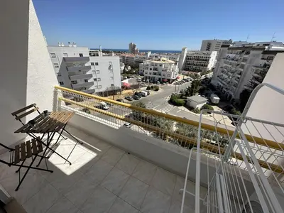 a balcony with chairs and a view of a city at Go4Portugal - Dinis - Luxe Condo with Pool, Airco, Seaview with two Balcony in Albufeira