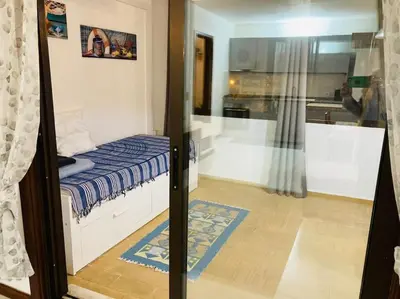 a small bedroom with a bed and a bathroom at House Т1 Bella Vista in Albufeira