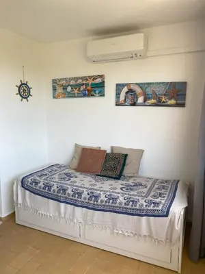 a bedroom with a bed with a book on it at House Т1 Bella Vista in Albufeira