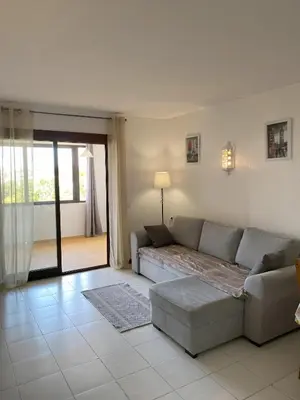 a living room with a couch and a table at House Т1 Bella Vista in Albufeira