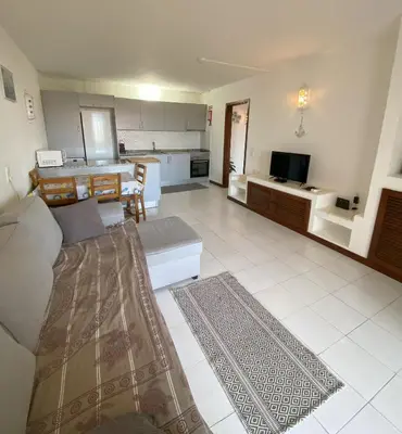a living room with a couch and a kitchen at House Т1 Bella Vista in Albufeira