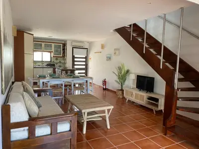 a living room with a couch and a staircase at Beach Villa Alfamar Praia da Falésia in Albufeira