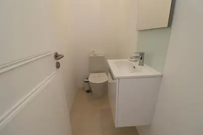 a white bathroom with a sink and a toilet at São Rafael Beach Apartment 92A, Albufeira - Algarve in Albufeira