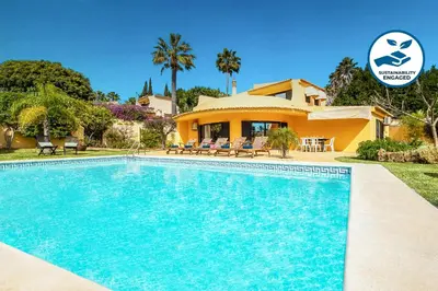 a villa with a swimming pool in front of a house at Villa Samui by Algarve Vacation in Albufeira