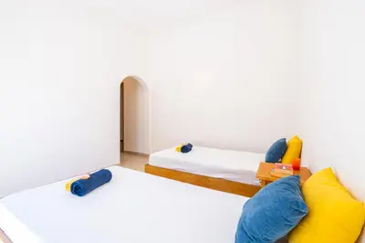 a bedroom with two beds with yellow and blue pillows at Villa Samui by Algarve Vacation in Albufeira