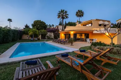 a villa with a swimming pool and a house at Villa Samui by Algarve Vacation in Albufeira