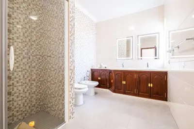 a bathroom with a shower and a toilet and a sink at Villa Rose Bay by Algarve Vacation in Albufeira