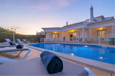 a villa with a swimming pool and a house at Villa Rose Bay by Algarve Vacation in Albufeira