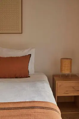 a bedroom with a bed and a wooden night stand at Casa Terra with Pool & Free WiFi in Albufeira
