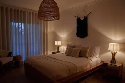 a bedroom with a bed with two lamps and a window at Casa Terra with Pool & Free WiFi in Albufeira