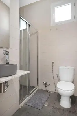 a bathroom with a toilet and a sink and a shower at Poolside Villa Sereno in Albufeira