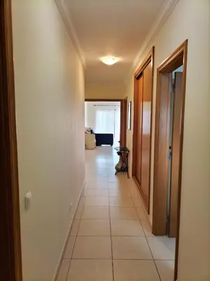 a hallway of a house with a tile floor at T2 Infante AC wifi Garagem 50m Praia in Quarteira
