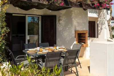 a table with plates of food on a patio at Moradia Olhos de Água - 3 quartos - 6 camas in Albufeira