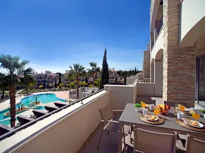 a patio with a table and chairs on a balcony at Apartment Pine Hills Cristal by Interhome in Vilamoura