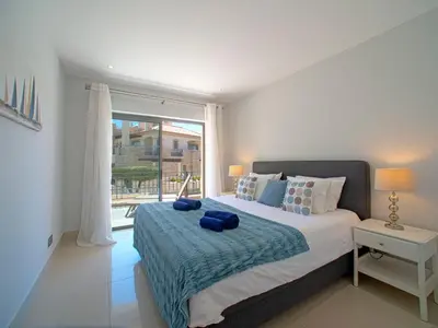 a swimming pool with lounge chairs and a resort at Apartment Pine Hills Ambar by Interhome in Vilamoura