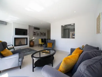 a living room with a couch and a table at Apartment Pine Hills Ambar by Interhome in Vilamoura