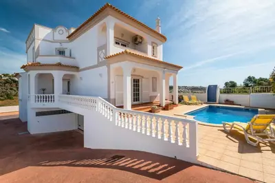 a villa with a swimming pool and a house at Villa Chris by Gabi Miguel in Albufeira