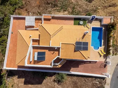 an overhead view of a yellow house with a swimming pool at Villa Chris by Gabi Miguel in Albufeira