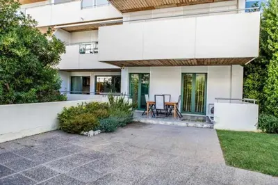 a white house with a patio and a table at Marina Vilamoura - Aquamar 009 - By Vilamoura Sun in Loulé
