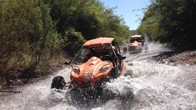 an orange atv driving through the water on a road at Marina Vilamoura - Aquamar 009 - By Vilamoura Sun in Loulé