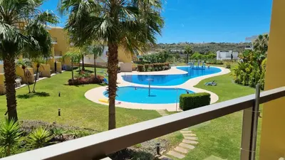a view of the pool from the balcony of a resort at Splendide Appartement Standing Casa Biblos en Famille ou en Amoureux in Albufeira