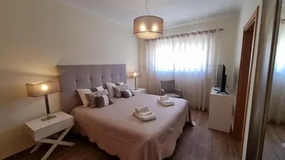 a bedroom with a large bed with two towels on it at Splendide Appartement Standing Casa Biblos en Famille ou en Amoureux in Albufeira