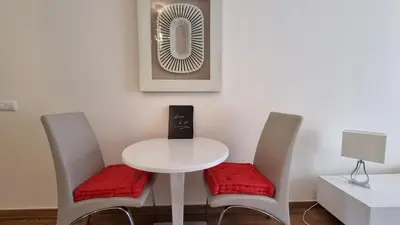 a white table with two chairs and a fan at Splendide Appartement Standing Casa Biblos en Famille ou en Amoureux in Albufeira