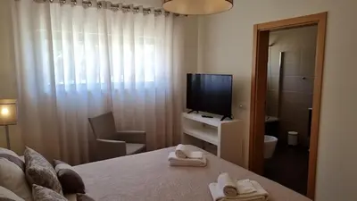 a bedroom with a tv and a bed with towels at Splendide Appartement Standing Casa Biblos en Famille ou en Amoureux in Albufeira