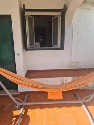 a hammock in a room with a mirror at Vilamoura Alecrim in Vilamoura
