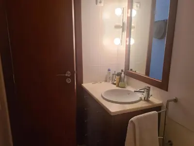 a bathroom with a sink and a mirror at Vilamoura Alecrim in Vilamoura