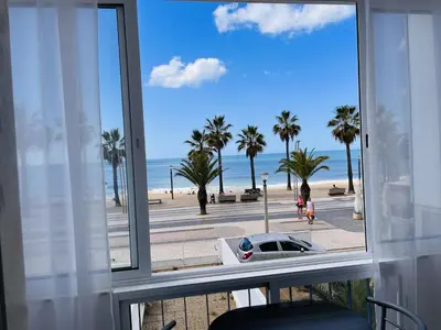 a view of the beach from a room with a window at Julias Beach Retreat in Quarteira