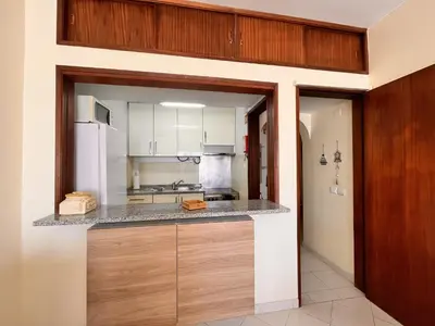 a kitchen with white cabinets and a counter top at Julias Beach Retreat in Quarteira