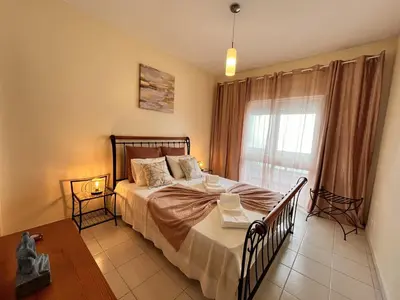 a bedroom with a large bed and a window at Julias Beach Retreat in Quarteira
