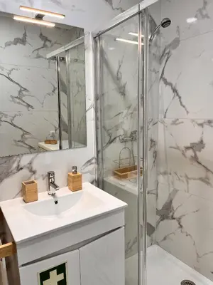 a bathroom with a sink and a shower at Julias Beach Retreat in Quarteira