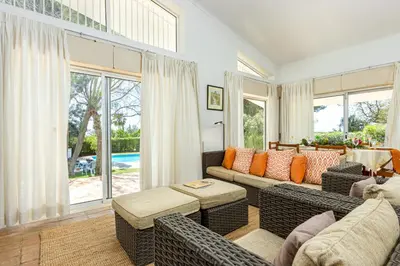 a living room with a couch and a table at Villa Bolota in Albufeira