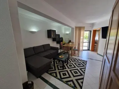 a living room with a couch and a table at Charming Beachside Apartment- The Perfect Getaway! in Albufeira