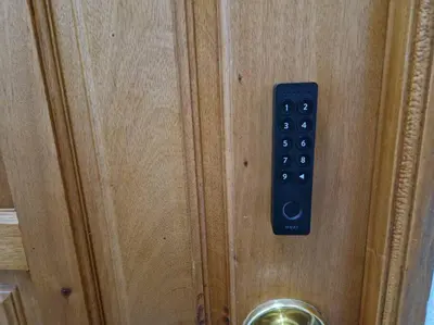 a black remote control on a wooden door at Charming Beachside Apartment- The Perfect Getaway! in Albufeira