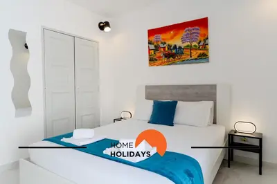 a bedroom with a bed with a poster on the wall at #265 Charming Villa Sam in Albufeira